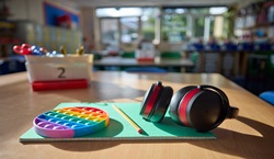 Fidget toy and ear defenders in classroom
