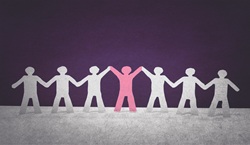 Paper people hand in hand celebrating the middle person with arms in the air
